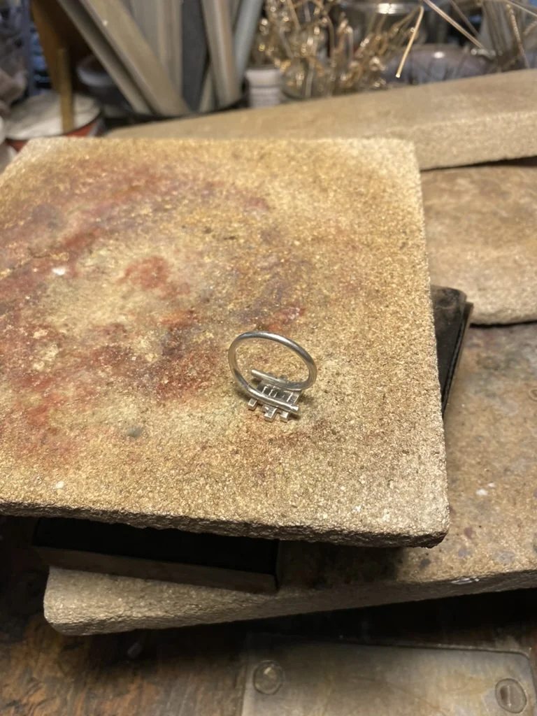 Silver ring on a soldering block, top view
