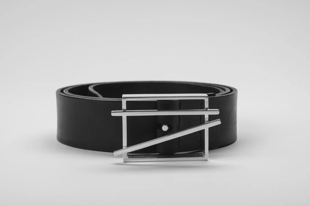 Finished silver belt buckle on the coiled leather belt, front view